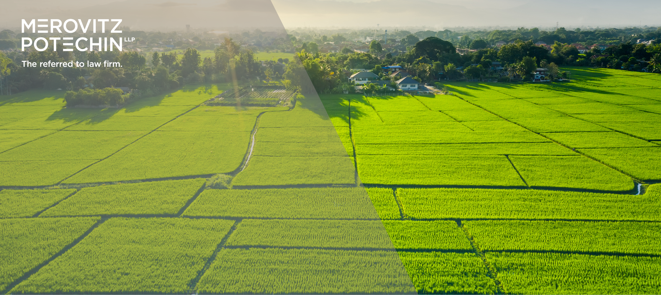 Arial view of green agricultural fields with residential homes in the background, representing land development and property boundaries - Merovitz Potechin LLP, the referred-to law firm.