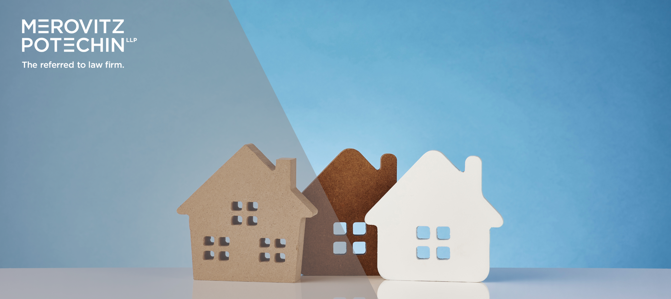 Three small house models in different shades of brown and white, with the Merovitz Potechin LLP logo and the text 'The referred to law firm' in the top left corner against a blue background.