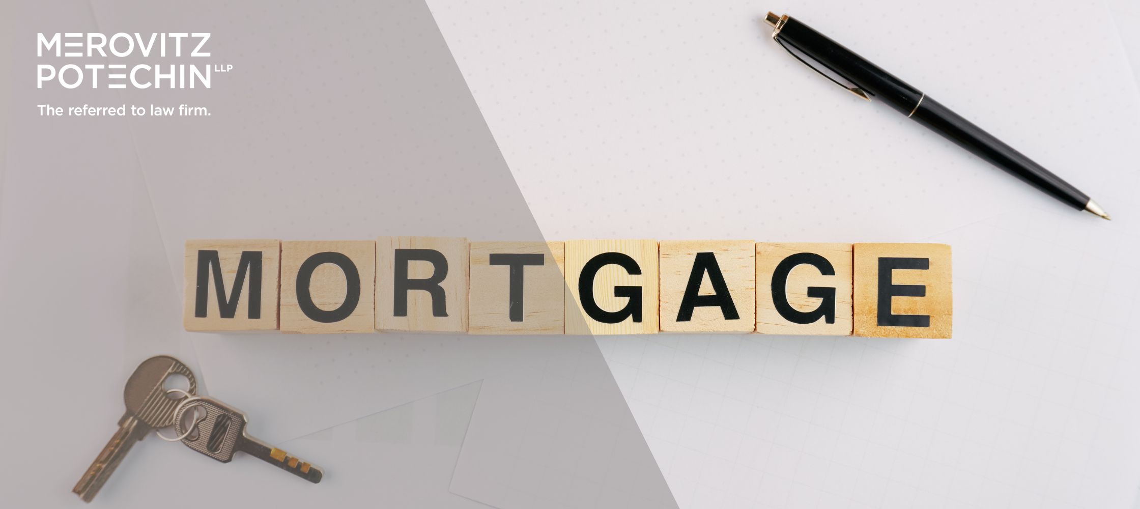 Wooden blocks spelling out 'MORTGAGE' with keys and a pen on a desk, representing real estate and mortgage concepts