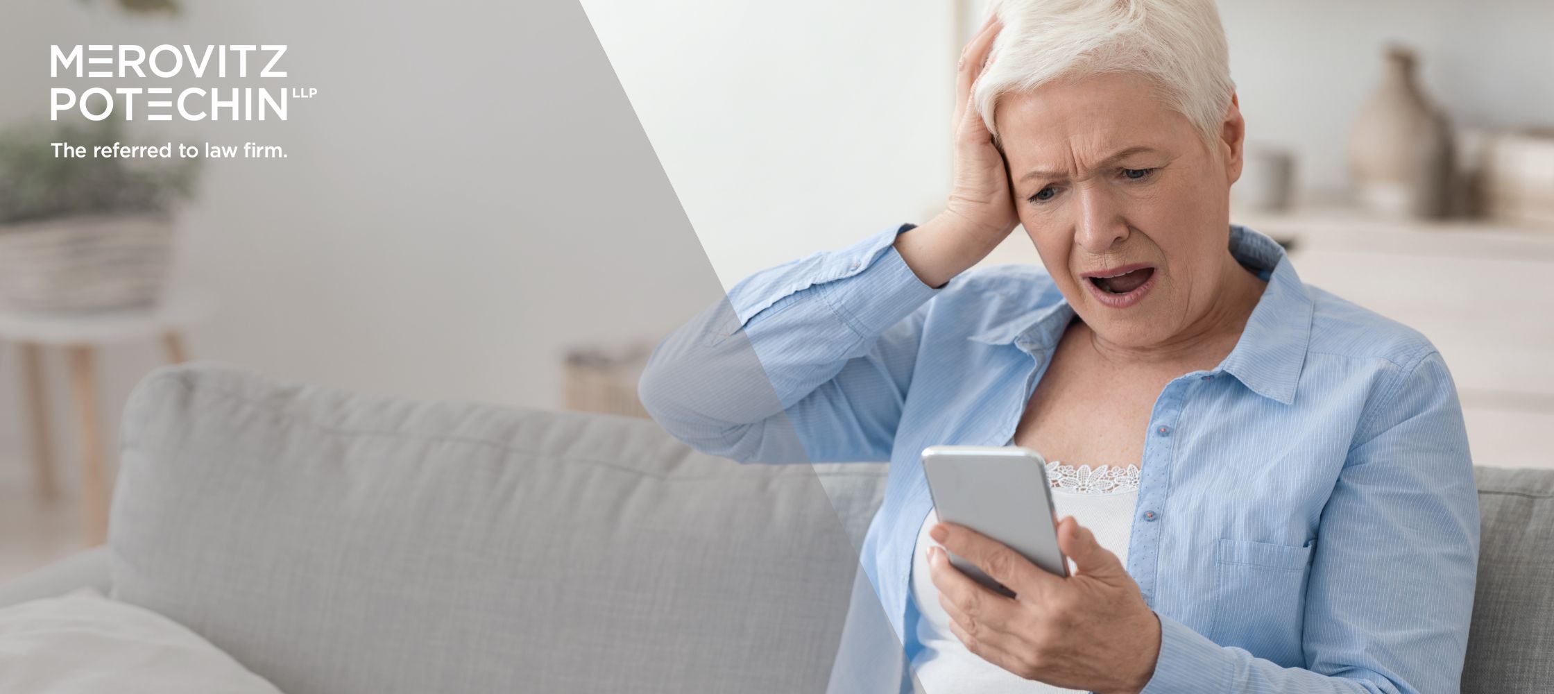 An older woman sitting on a couch, looking shocked and distressed while holding her smartphone, possibly a victim of romance scams. She has her hand on her head in disbelief. The logo of Merovitz Potechin LLP appears in the corner, with the tagline 'The referred to law firm.