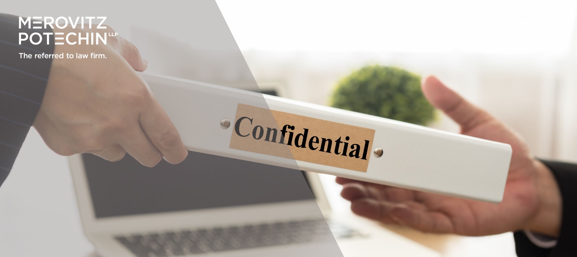 Close-up of two professionals exchanging a binder labeled 'Confidential,' symbolizing protective orders, secure document handling, and confidentiality in legal practices.